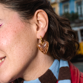Wildly In Love Bambi heart earring worn by model — close-up detail