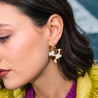 Wildly In Love Cow heart earring worn by model — close-up detail