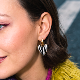 Wildly In Love Zebra heart earring worn by model — close-up detail